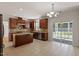 Open kitchen with granite countertops, stainless steel appliances, tile floors, cherry cabinets, and sliding door at 2017 Ollivander Dr, Cary, NC 27519