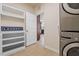 Laundry room with a stacked washer/dryer and built-in shelves at 2017 Ollivander Dr, Cary, NC 27519