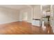 Bright and open-concept living room with wood floors and view of the kitchen and entryway at 2017 Ollivander Dr, Cary, NC 27519