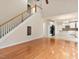 Open-concept living space with stairs, hardwood floors, and adjacent eat-in kitchen at 2017 Ollivander Dr, Cary, NC 27519