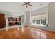 Sunlit living room with hardwood floors, large window seat, and open access to the kitchen at 2017 Ollivander Dr, Cary, NC 27519
