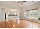 Open floor plan with hardwood floors, view into kitchen and a window seat with view at 2017 Ollivander Dr, Cary, NC 27519