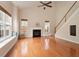 Spacious living room with hardwood floors, a fireplace, large windows and a ceiling fan at 2017 Ollivander Dr, Cary, NC 27519