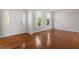 Spacious living room featuring hardwood floors and natural light from large windows at 2017 Ollivander Dr, Cary, NC 27519