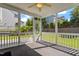 Cozy screened porch featuring an outdoor ceiling fan and backyard views at 2017 Ollivander Dr, Cary, NC 27519