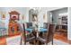 Dining area featuring a glass table set, hardwood floors, and an elegant display cabinet at 208 Abigail Ln, Gibsonville, NC 27249