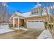 Charming home with a stone facade, complemented by a well-manicured lawn and a two-car garage during winter at 208 Abigail Ln, Gibsonville, NC 27249