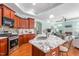Open kitchen featuring a large island, stainless steel appliances, and cherry cabinets at 208 Abigail Ln, Gibsonville, NC 27249