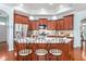 Cherry kitchen island with granite countertops and bar seating with stainless appliances at 208 Abigail Ln, Gibsonville, NC 27249