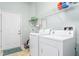 Functional laundry room with a washing machine and dryer, along with storage shelving at 208 Abigail Ln, Gibsonville, NC 27249
