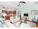 Open-concept living room with hardwood floors, a ceiling fan, and a view of the kitchen at 208 Abigail Ln, Gibsonville, NC 27249