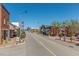 View down a tree-lined downtown street with colorful awnings in an urban setting at 2313 Eagle Shot Ct # 29, Fuquay Varina, NC 27526