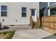 Rear exterior view displays back door with wooden steps and concrete patio at 237 Daniel Ridge Rd, Wendell, NC 27591