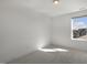 Bright white bedroom with large window and plush carpet flooring at 237 Daniel Ridge Rd, Wendell, NC 27591