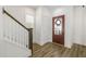 Entryway with wood-look floors, a staircase, and a striking red door with glass insert at 237 Daniel Ridge Rd, Wendell, NC 27591