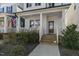 Inviting front porch featuring classic columns, a wood door with wreath, and groomed landscaping at 237 Daniel Ridge Rd, Wendell, NC 27591