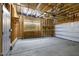 Spacious garage interior with workbench, storage shelving, and overhead door system at 237 Daniel Ridge Rd, Wendell, NC 27591