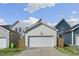 Detached two-car garage with white door and siding complements the home's exterior at 237 Daniel Ridge Rd, Wendell, NC 27591