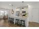 Modern kitchen with a large island, white cabinets, pendant lighting, and stainless steel appliances at 237 Daniel Ridge Rd, Wendell, NC 27591