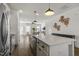 Kitchen island with sink, stainless steel appliances, and an open view into the living area with hardwood floors at 237 Daniel Ridge Rd, Wendell, NC 27591