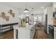 Open-concept kitchen with an island, stainless steel appliances, and hardwood floors connecting to a dining area at 237 Daniel Ridge Rd, Wendell, NC 27591