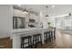 Modern kitchen featuring an island with bar stools, stainless steel appliances, and classic white cabinetry at 237 Daniel Ridge Rd, Wendell, NC 27591