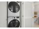 Close up of stacked washer and dryer in laundry closet, with door to bathroom at 237 Daniel Ridge Rd, Wendell, NC 27591