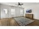 Modern living room with hardwood floors, a ceiling fan, a TV, and large windows with sheer curtains at 237 Daniel Ridge Rd, Wendell, NC 27591