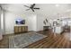Open-concept living area with hardwood floors, a TV, and a view into the kitchen and dining spaces at 237 Daniel Ridge Rd, Wendell, NC 27591