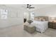 Cozy main bedroom featuring neutral carpet, a ceiling fan, a comfortable bed, and an ensuite bathroom at 237 Daniel Ridge Rd, Wendell, NC 27591