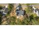 An aerial view of the home shows the roof, driveway and surrounding trees at 25 Arbor Dr, Youngsville, NC 27596