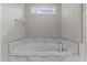 Modern bathroom features a soaking tub with marble surround and stylish fixtures at 25 Arbor Dr, Youngsville, NC 27596
