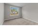 Cozy bedroom featuring plush carpeting, baseboard molding, and a bright window at 25 Arbor Dr, Youngsville, NC 27596
