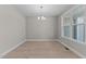 Dining room featuring elegant chandelier, hardwood floors, and bright natural light at 25 Arbor Dr, Youngsville, NC 27596