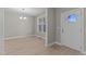 Inviting entryway with hardwood flooring, a modern chandelier, and plenty of natural light at 25 Arbor Dr, Youngsville, NC 27596