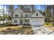 Charming two-story home with a well-maintained lawn and attached two-car garage at 25 Arbor Dr, Youngsville, NC 27596