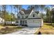 Charming two-story home with a well-maintained lawn and attached two-car garage at 25 Arbor Dr, Youngsville, NC 27596