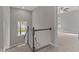 Brightly lit hallway with wooden railing and plush carpet at 25 Arbor Dr, Youngsville, NC 27596