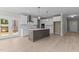 Bright kitchen featuring a center island, stainless steel appliances, and access to the deck at 25 Arbor Dr, Youngsville, NC 27596