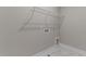 Bright laundry room features tile flooring and wire shelving for easy storage solutions at 25 Arbor Dr, Youngsville, NC 27596