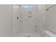 Shower featuring white marble tile and a glass window at 25 Arbor Dr, Youngsville, NC 27596