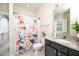 Neutral bathroom with a single sink vanity, a combined shower and tub with colorful shower curtain at 260 Culbreth Rd, Chapel Hill, NC 27516