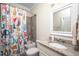 Cozy bathroom showcasing a playful shower curtain, granite countertop, and ample lighting at 260 Culbreth Rd, Chapel Hill, NC 27516