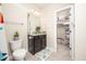 A functional bathroom with a granite-topped vanity and a convenient closet at 260 Culbreth Rd, Chapel Hill, NC 27516