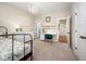 Bright bedroom showcasing a decorative chandelier, dresser and a peek into the ensuite bath at 260 Culbreth Rd, Chapel Hill, NC 27516