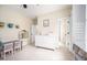 This bedroom is adorned with a unique chandelier, a grey desk and views to a bath at 260 Culbreth Rd, Chapel Hill, NC 27516