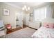 Comfortable bedroom with a floral rug, white dresser, and connected ensuite bathroom at 260 Culbreth Rd, Chapel Hill, NC 27516