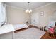 Charming bedroom designed with floral rug, a small table, and a pink 'R' wall decor at 260 Culbreth Rd, Chapel Hill, NC 27516