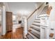Inviting entryway with hardwood floors, staircase, and view into the living room with fireplace at 260 Culbreth Rd, Chapel Hill, NC 27516