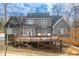 Beautiful two-story home showcasing a spacious deck with string lights and cozy hanging chairs at 260 Culbreth Rd, Chapel Hill, NC 27516